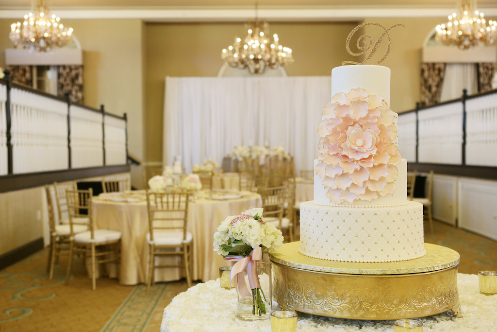 Four Tiered Round White Wedding Cake on Gold Cake Topper with Blush Pink Floral Frosting and Stylish Gold Glitter Initial Cake Topper | St Pete Wedding Venue The Don CeSar