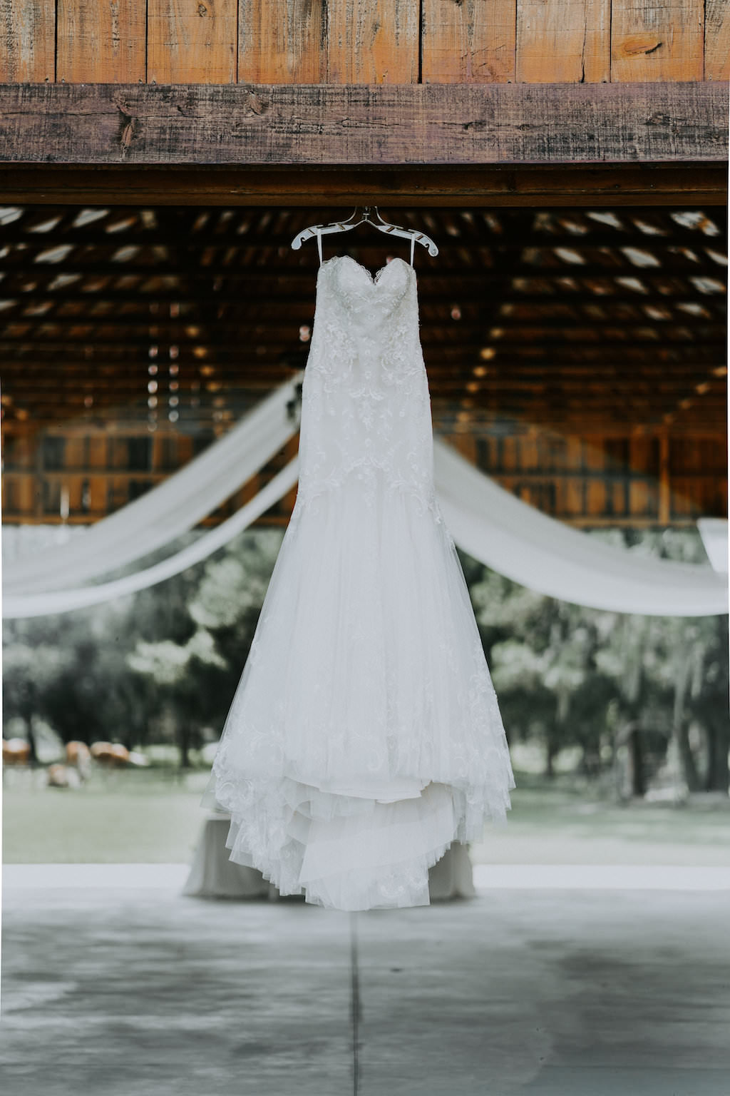 Rustic Barn Wedding Reception Venue with Sweetheart A Line Wedding Dress on Hanger