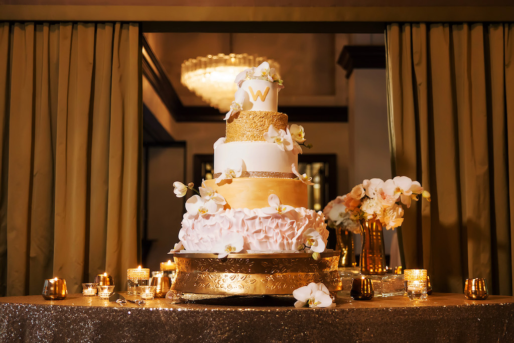 Five Tiered Round Gold and White Wedding Cake with Blush Petal Layer and Orchid Decorations on Gold Cake Tray