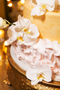 Gold and Blush Wedding Cake Detail with White Orchids on Gold Cake Tray