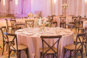 Low Pink and White Centerpiece with Greenery in Gold Vase with Blush Pink Linens and Natural Wood Chiavari Chairs