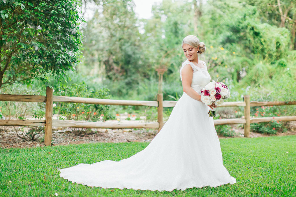 Outdoor Garden Bridal Portrait with Blush, Red, and Cream Rose Bouquet and Lace Wedding Dresses | Tampa Bay Wedding Photographer Rad Red Creative | Bridal Shop Truly Forever Bridal