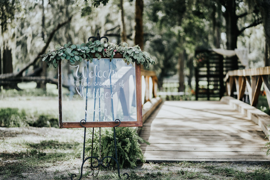 Stylish Wedding Ceremony Wedding Sign with Garland | Tampa Bay Outdoor Garden Wedding