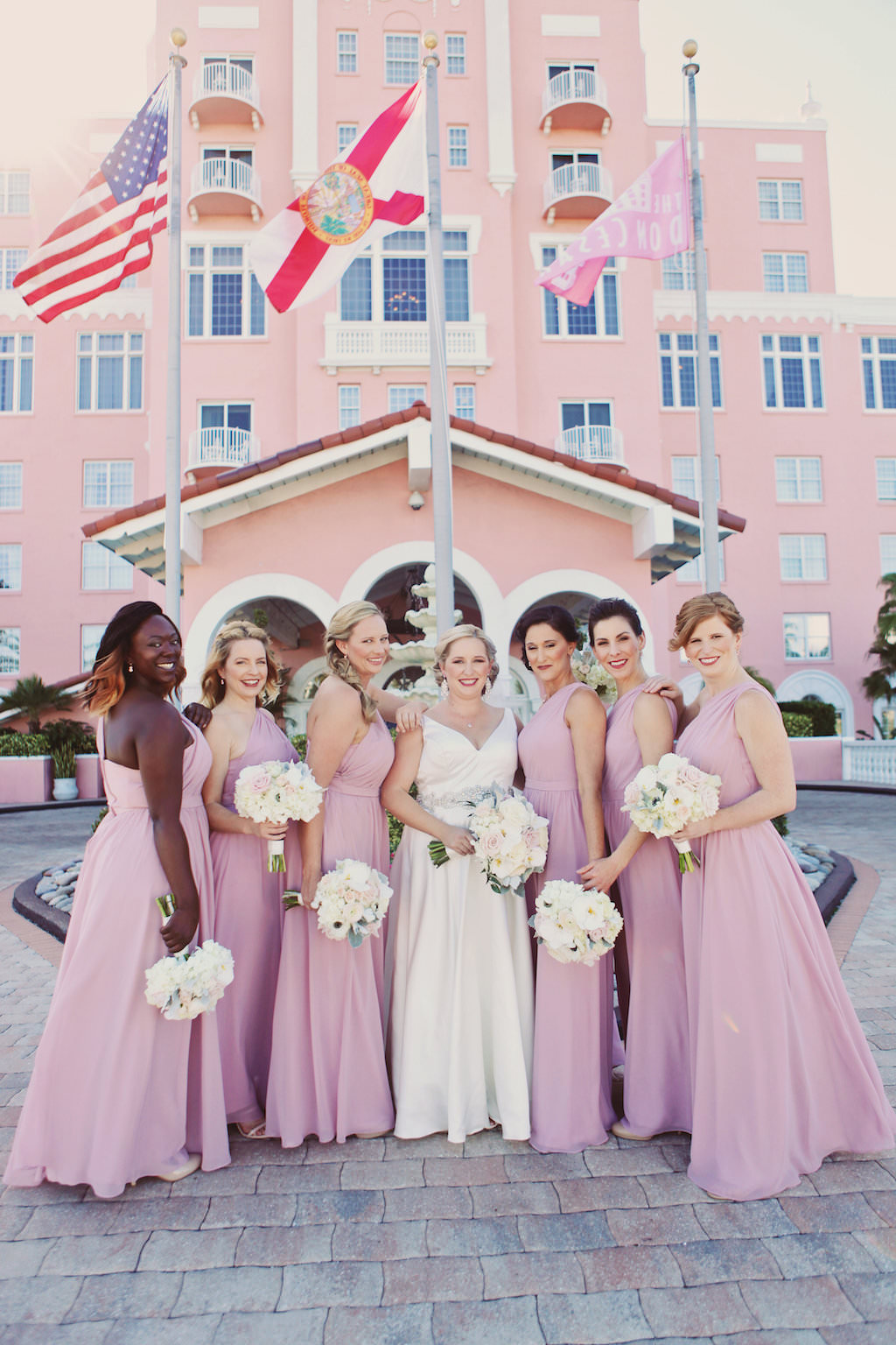 Bridal Party Portrait with Lilac Asymetrical One Shoulder Bridesmaids Dresses and White and Blush Bouquets | Tampa Bay Wedding Venue The Don CeSar