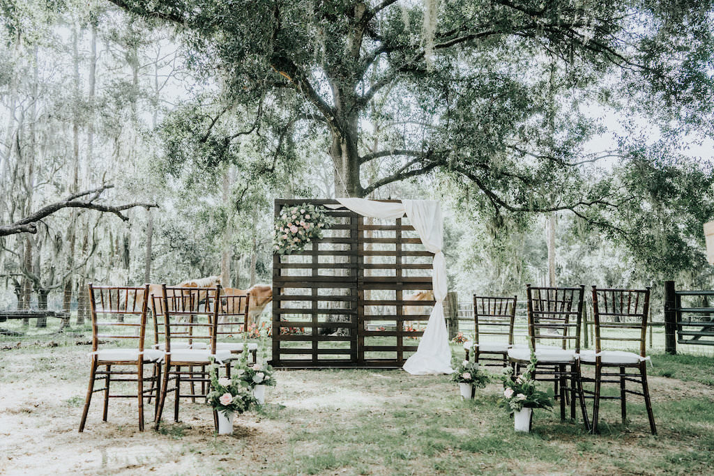 Rustic Garden Wedding Ceremony with Wooden Pallet Ceremony Backdrop with Flowers and White Drapery | Blush Rose and Fern Flowers in White Ceramic Pots | Tampa Bay Wedding Planner Kelly Kennedy Weddings and Events