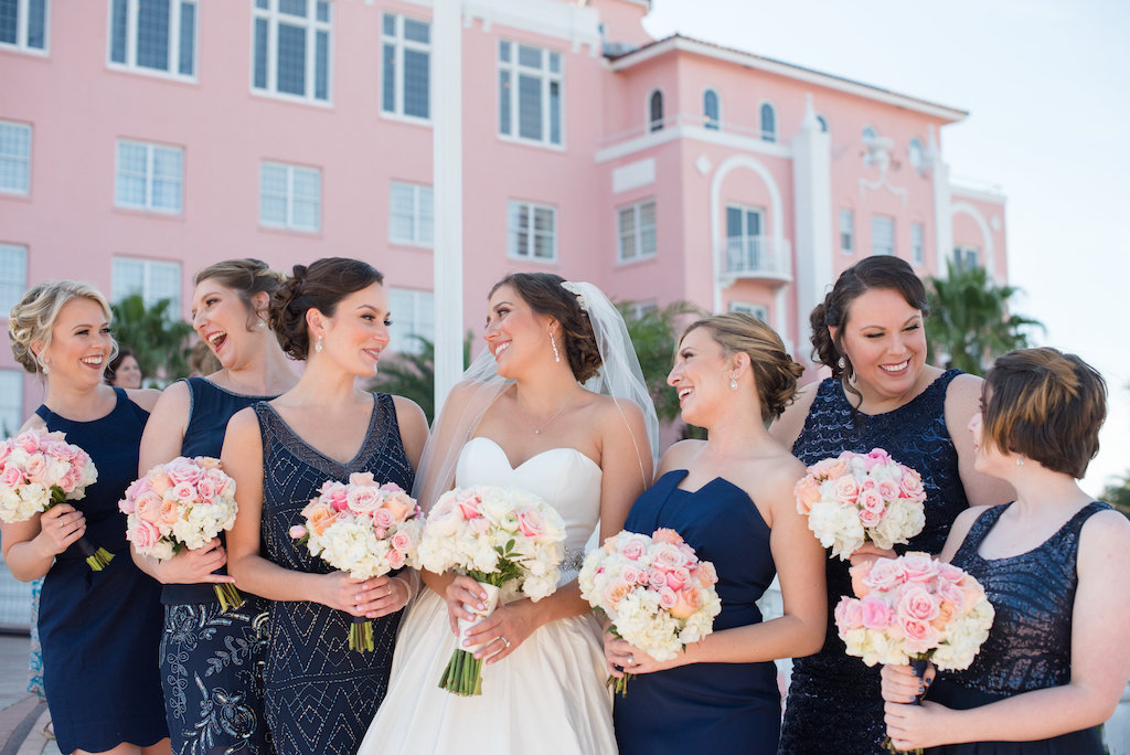 Bridal Party Portrait Outside St Pete Beach Wedding Venue The Don Cesar, with Mismatched Beaded Navy Blue Bridesmaids Dresses and Pink and White Bouquets | Tampa Bay Wedding Photographer Caroline and Evan Photography