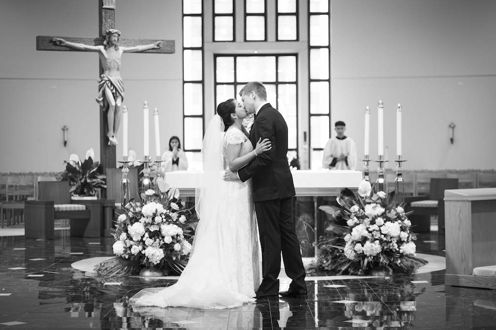 Traditional Church Wedding Ceremony First Kiss Portrait with Large White and Greenery Florals | St Petersburg Wedding Ceremony Venue Cathedral of St Jude