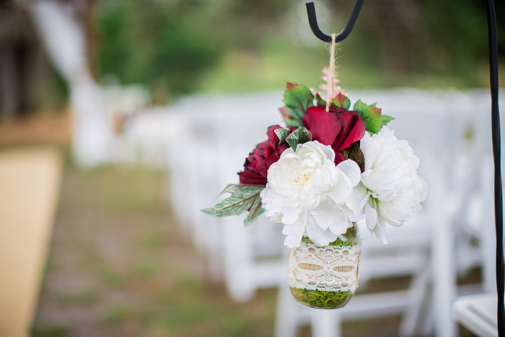 Outdoor Wedding Ceremony Decor Detail of White Peony and Burgundy Rose in Lace Decorated Hanging Mason Jar
