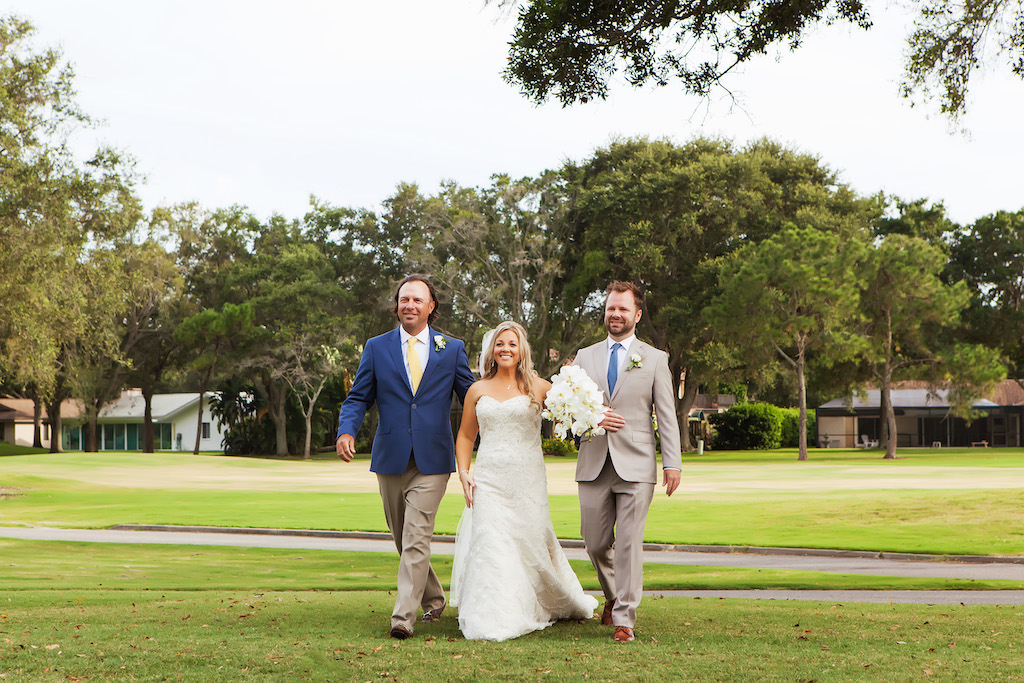 Bride Walking Down Ceremony Aisle Portrait with Groomsmen with White Bouquet