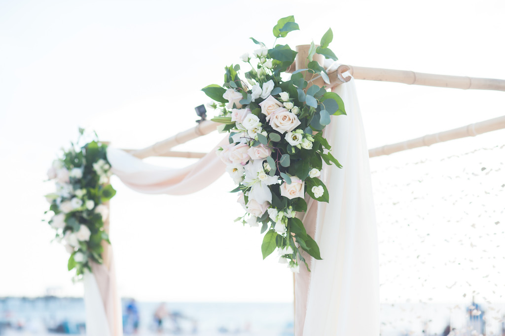Beach Wedding Ceremony Arch with Bamboo, Blush and White Roses with natural Greenery and Blush Drapery | Tampa Bay Boho Beach Wedding Decor