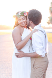 Outdoor Sunset Wedding Bride and Groom Portrait, Groom in Suspenders and Tan Pants in White Cotton Shirt, Bride in Boho Collumn Wedding Dress with Peach and Blush Rose with Greenery Floral Crown Hair Accessory | St Pete Outdoor Wedding Venue Lake Maggiore Park