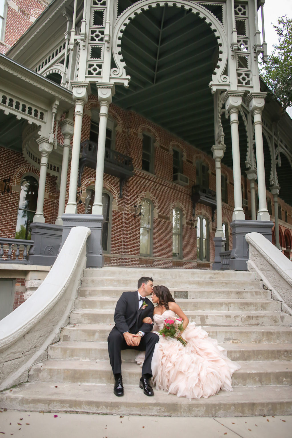 Outdoor Architectural Tampa Bride and Groom Wedding Portrait, Bride in Layered Blush Wedding Dress with Magenta Bridal Bouquet | Tampa Bay Wedding Photography Lifelong Studios