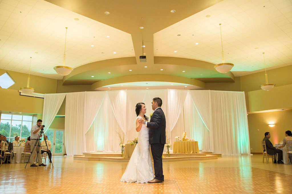 First Dance Portrait, Groom with Yellow Boutoniere | Vietnamese Inspired Wedding Reception with White Draping, Gold Linens, and Tall Natural Florals | Tampa Bay Wedding Rentals Gabro Event Services | Tampa Wedding Photographer Kristen Marie Photography