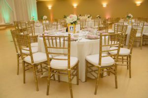 Gold, Blush, and Light Green Vietnamese Inspired Wedding Reception Table Decor with Small White and Pink with Greenery Centerpiece, Gold Chiavari Chairs, White and Pink Linens, and Gold Framed Table Number | Tampa Bay Event Rentals Gabro Event Services