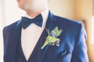 Navy Blue Groom Tuxedo with Blue Thistle and Purple Flowers and Greener Boutonniere