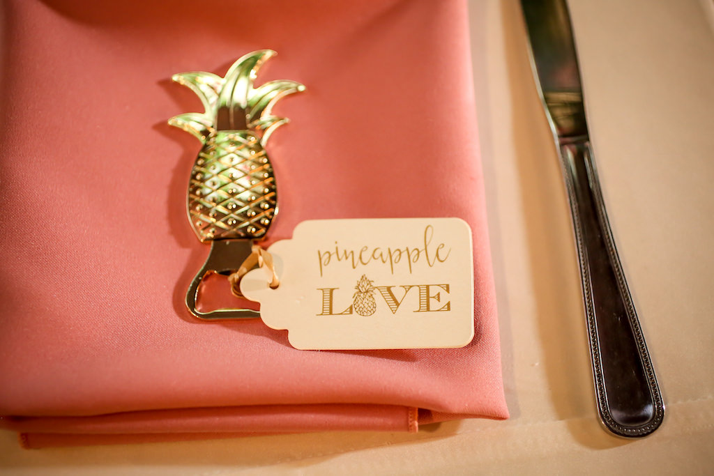Gold and Pink Tropical Wedding Reception Table with Gold Pineapple Bottle Opener Favor on Pink Napkin