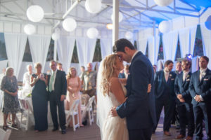 Boho Beach Wedding Hotel Reception First Dance Portrait with White Draping and Hanging White Chinese Lanterns, Groomsmen in Navy Suits with Blush Ties | Clearwater Beach Hotel Wedding Venue Hilton Clearwater Resort & Spa