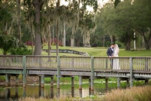 Outdoor Garden Bride and Groom Wedding Portrait on Wooden Bridge, Groom in Gray Tuxedo | Tampa Wedding Photographer Andi Diamond Photography | Tampa Bay Garden Wedding Venue The Palms Tampa Golf And Country Club