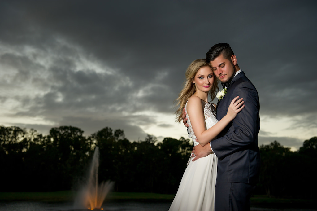 Outdoor Nighttime Bride and Groom Garden Wedding Portrait, Groom in Gray Tuxedo with White Floral Boutonniere | Tampa Bay Wedding Photographer Andi Diamond Photography | Tampa Wedding Makeup and Hair Artist Michele Renee The Studio