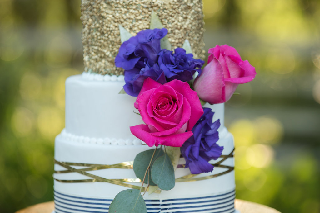 Colorful Three Tier Round White Wedding Cake with Gold Foil and Navy Stripes and Pearls on Gold Cake Stand, with Purple and Hot Pink Roses | Tampa Bay Wedding Cake Bakery A Piece of Cake