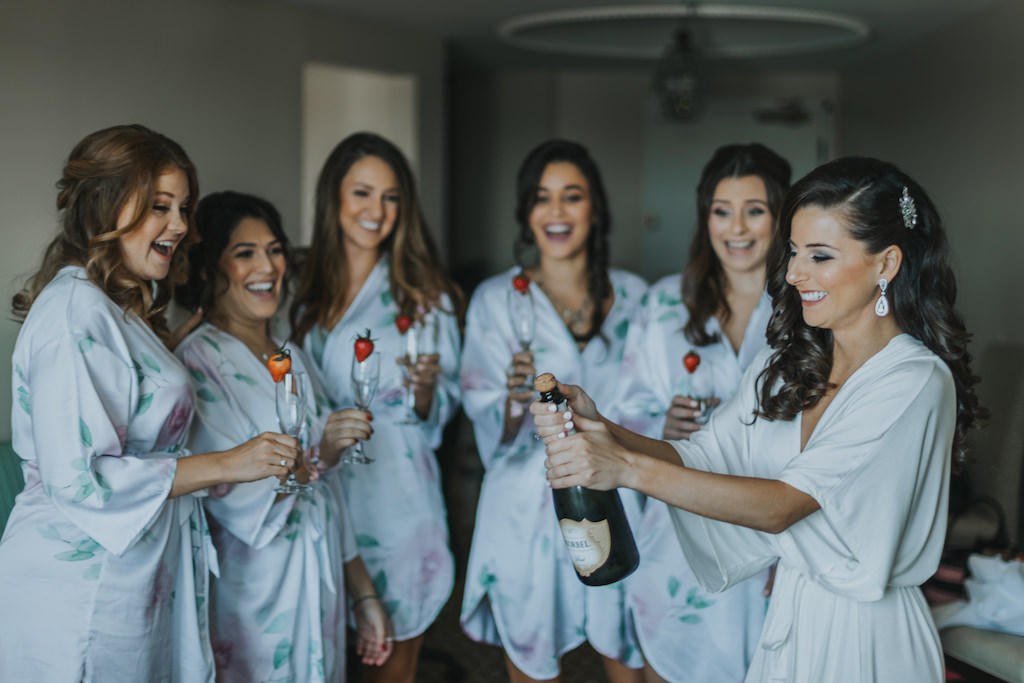 Bridal Party Getting Ready Portrait in Matching Blue Silk Floral Robes with Champagne | Bridal Getting Ready Accommodations St Pete Historic Hotel Wedding Venue The Vinoy Renaissance