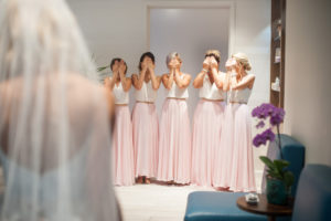 Bridal Party Getting Ready First Look Portrait with Two Piece White Tops and Long Blush Pink Skirts Bridesmaids Dresses | Boho Wedding Style