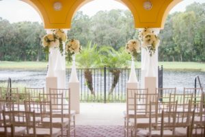 Elegant Wedding Ceremony Decor with Tall Hydrangea Florals with Greenery in Bold White Vases on Pedestals and White Chiavari Chairs | Tampa Bay Country Club Wedding Venue The Palms Tampa Golf & Country Club | Tampa Wedding Rentals A Chair Affair | Wedding and Event Planner Love Lee Lane | Florist and Rentals Gabro Event Services