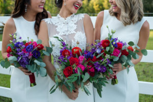 Outdoor Bridal Party Portrait with Red, Purple, and Greenery Bouquet from Tampa Florist Northside Florist, in A Line Lace Wedding Dress from The Bride Tampa, Bridesmaids in Classic White Dresses from Truly Forever Bridal | Hair and Makeup by Michele Renee The Studio | Caroline & Evan Photography