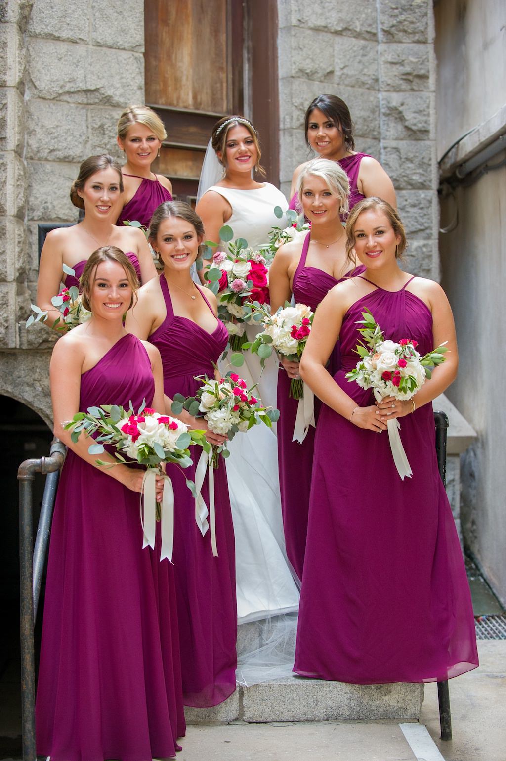 Outdoor Church Steps Bridal Party Portrait with Magenta and White Rose with Greenery and Ribbon Bouquets, Bridesmaids in Mismatched Mauve Dresses | Tampa Bay Wedding Photographer Andi Diamond Photography