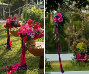 Outdoor Rustic Wedding Ceremony Decor Details with Wooden Benches, and Small Red, Purple, and Magenta Flowers with Pink and Purple Ribbon, and Hanging Woven Branch Wreaths with Ribbon and Purple and Pink Roses | Tampa Bay Wedding Florist Northside Florist