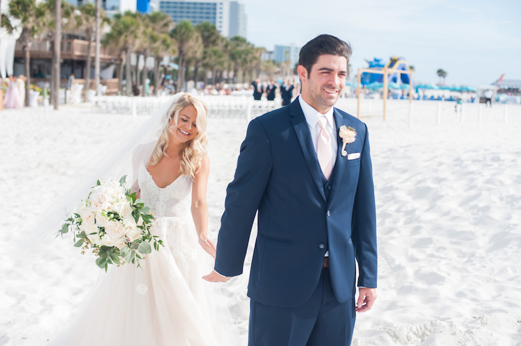 St Pete Beach Wedding Ceremony First Look Portrait, Bride with Blush and White Rose Bouquet with Greenery. Groom in Navy Blue Suit with Blush Tie | Clearwater Beach Wedding Venue Hilton Clearwater Resort & Spa