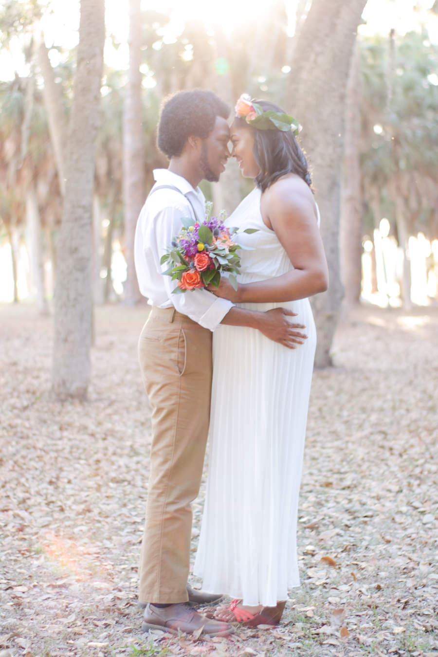 Summer Floral Bohemian Wedding Outdoor Bride and Groom Portrait with Peach Rose, Purple and Yellow Floral, Succulent and Greenery Wedding Bouquets, and Bright Purple and Blush Floral Hair Accessories, Groom with Suspenders and White Cotton Shirt, with Succulent, Pink and Yellow Floral Twine Wrapped Boutonniere | Tampa Bay Wedding Venue Lake Maggiore Park