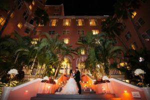 Outdoor Nighttime Courtyard Garden Wedding Ceremony Portrait with Floating Votive Candles in Glass Cylinder Vases | St Pete Beach Historic Hotel Wedding Venue The Don Cesar