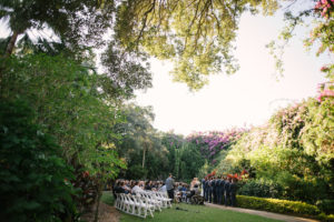 Outdoor Garden Wedding Ceremony Wedding Party Portrait, Groomsmen in Navy Suits with White Folding Chairs | Tampa Bay Wedding Venue Sunken Gardens