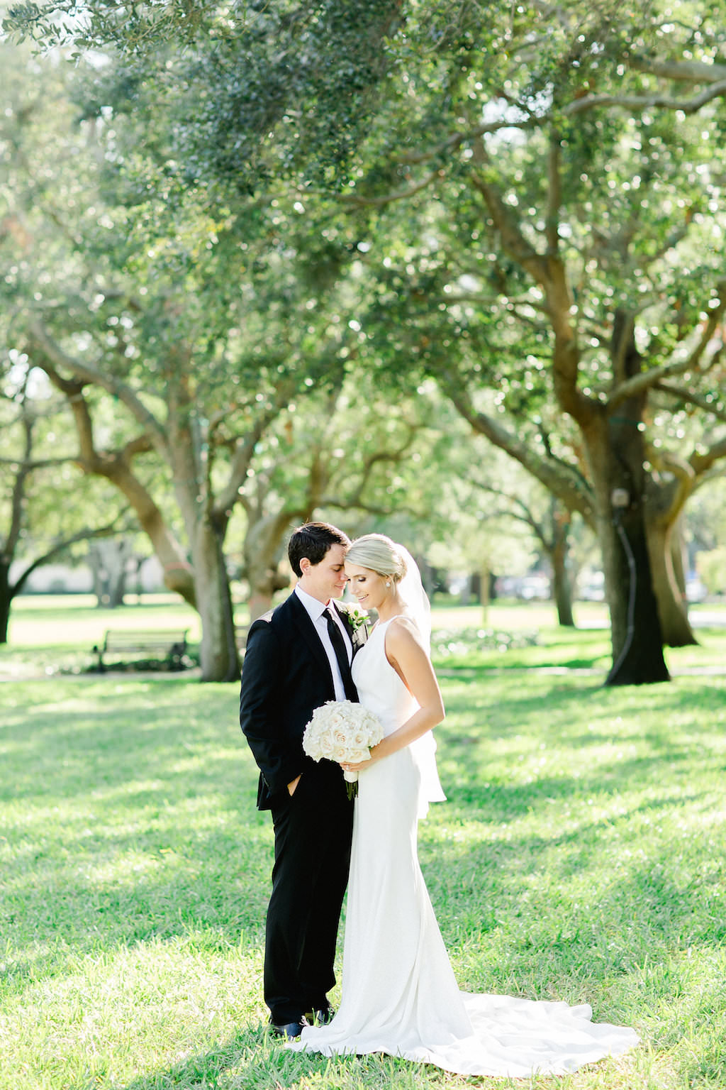Outdoor Garden Bride and Groom Wedding Portrait, Bride with Ivory Rose Bouquet, Groom with White Rose and Greenery Bouquet | Tampa Bay Wedding Photographer Ailyn La Torre Photography | Downtown St Pete Vinoy Park