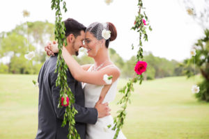 Outdoor Wedding Ceremony Portrait with Arch with White Drapery and Hanging Greenery Garlands with Red Roses and White Flowers and Wooden Folding Chairs | Clearwater Golf Course Wedding Venue Countryside Country Club | Planner Special Moments Event Planning | Florist and Decor Gabro Event Services