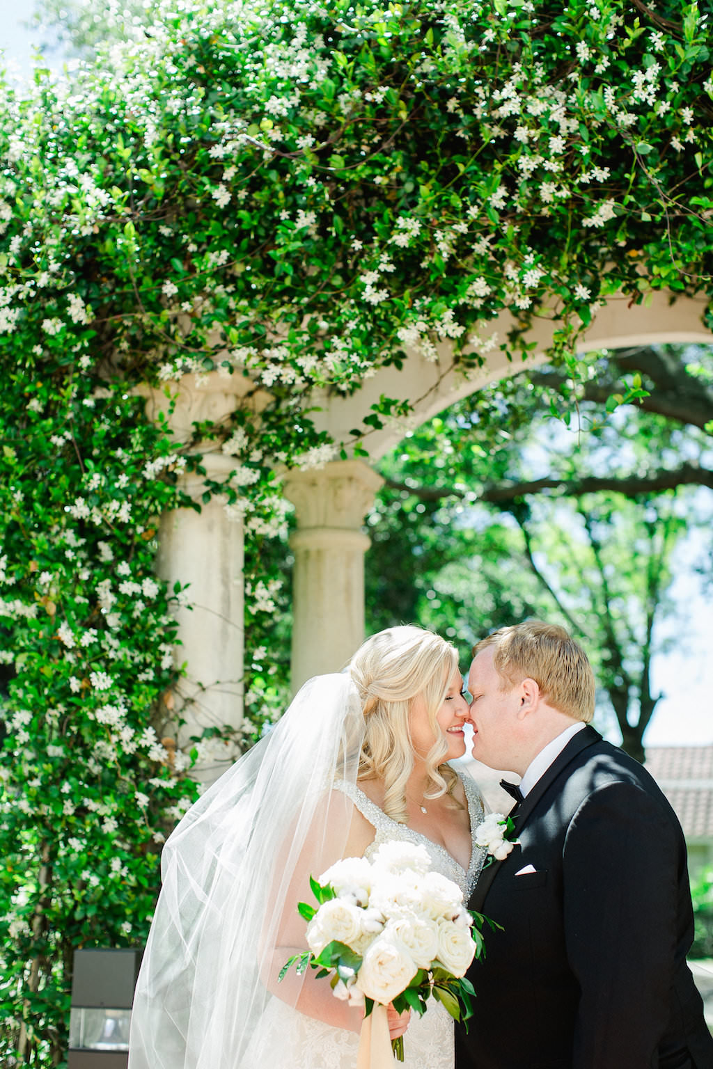 Outdoor Garden Wedding Portrait, Bride with White Garden Rose and Greenery Bouquet, Groom in Tuxedo with White Rose Boutonnière | Clearwater Wedding Photographer Ailyn La Torre Photography
