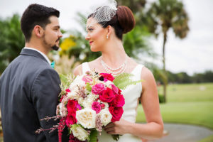 Outdoor Bridal Portrait in Birdcage Veil with Triple Strand Pearl Necklace with White Rose, Magenta and Fuchsia Flower, Succulent and Fern Greenery Bouquet, Groom in Grey Suit with Aqua Blue Bow Tie | Tampa Bay Wedding Hair and Makeup Michele Renee The Studio | Clearwater Florist Gabro Event Services