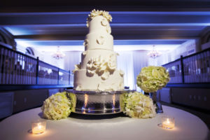 Four Tier Round White Wedding Cake with White Floral Icing with Green Hydrangea Bouquets