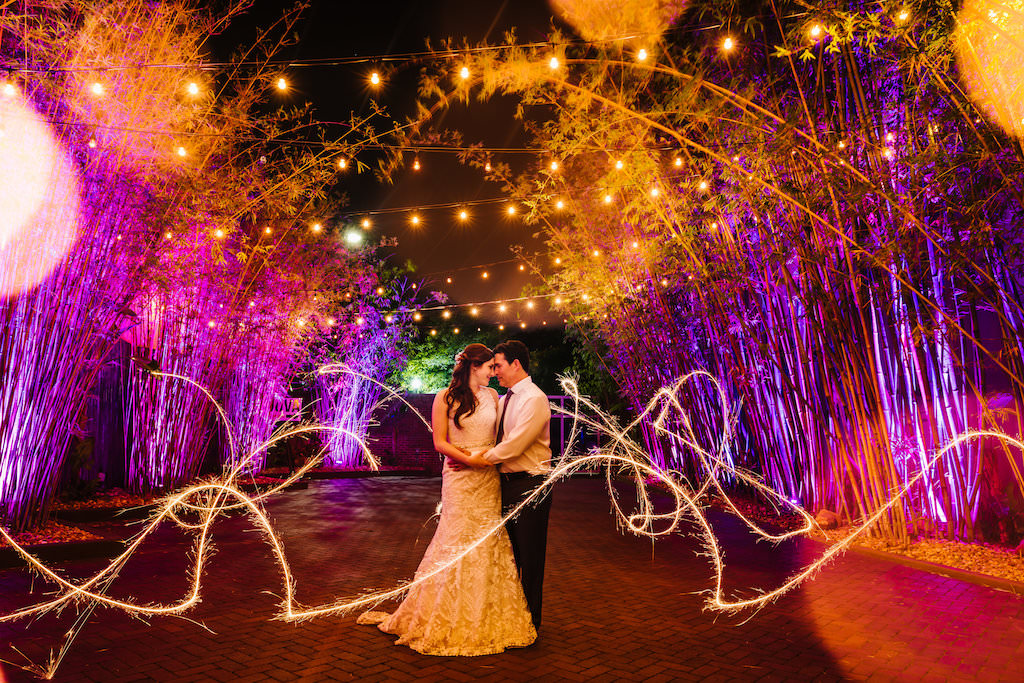 Outdoor Bamboo Garden Nighttime Bride and Groom Portrait with Sparklers at at Historic Downtown St Pete Wedding Venue NOVA 535 Bamboo Garden with String Lights
