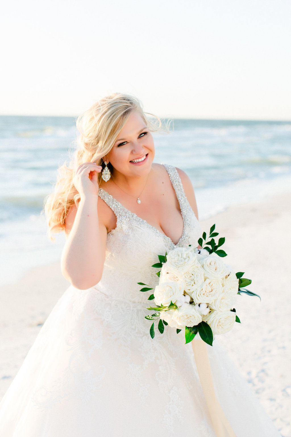 Clearwater Beach Wedding Bridal Portrait with Silver Beaded V Neck Ballgown Morilee by Madeline Gardner Wedding Dress with White Rose and Greenery Bouquet with Long Gold Ribbon | Tampa Bay Beachfront Wedding Venue The Carlouel Yacht Club | Photographer Ailyn La Torre Photography