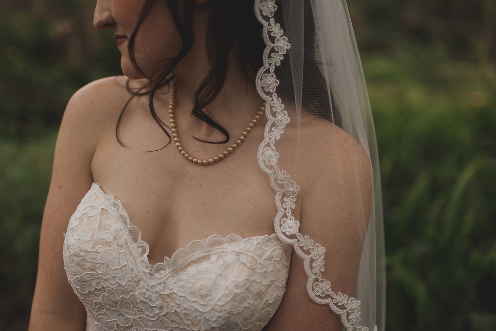 Outdoor Garden Bridal Portrait with Floral Lace Veil, Floral Lace Strapless Stella York Wedding Dress wearing Champagne Pearl Necklace | Tampa Bay Wedding Photography Stacy Paul Photography