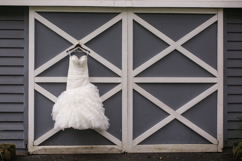 Strapless Allure Tulle Wedding Dress on Personalized Hanger on Barn Door