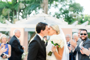 Outdoor Courtyard Garden Wedding Ceremony First Kiss Portrait with Ivory White Rose Bouquet with Greenery and White Ribbon | Tampa Bay Wedding Photographer Ailyn La Torre Photography | Downtown St Pete Historic Hotel Wedding Venue The Vinoy Renaissance