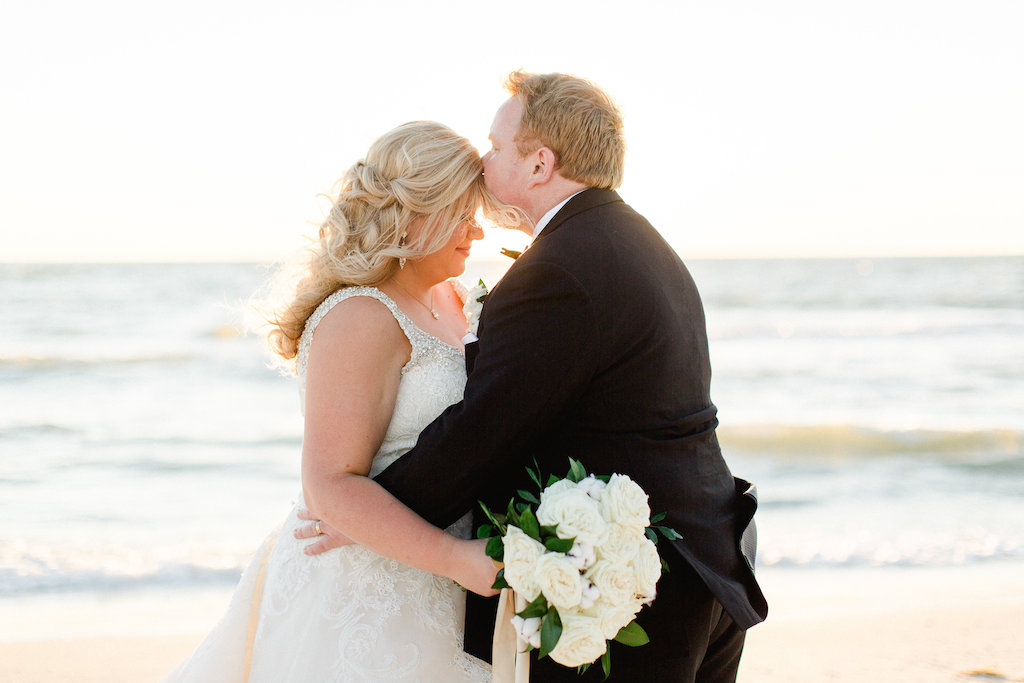 Beach Wedding Bride and Groom Portrait with White Rose and Greenery Bouquet with Long Gold Ribbon, Groom in Black Tuxedo | Tampa Bay Beachfront Wedding Venue The Carlouel Yacht Club | Clearwater Wedding Photographer Ailyn La Torre Photography