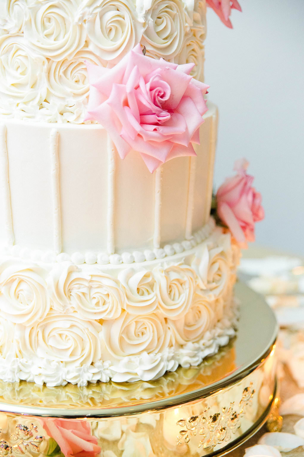 Elegant, Classic Four Tier Round White Wedding Cake with Alternating Rose and Vertical Icing and Pink Roses and Ivory Rose Petals on Gold Cake Stand | Wedding Cake Baker The Vinoy Renaissance