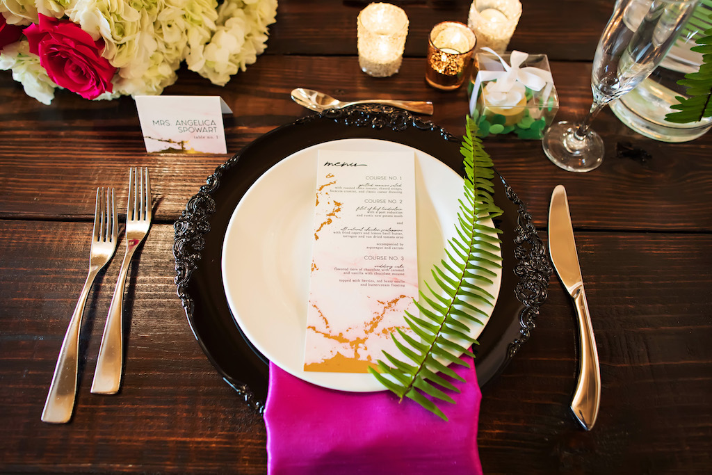 Wedding Reception Long Wooden Feasting Table Decor with Gold Foil and White Marble Paper Menu, Purple Napkin, Black Ceramic Charger, and Fern | Tampa Bay Wedding Planner Special Moments Event Planning | Clearwater Wedding Decor Rentals Gabro Event Services | Tampa Wedding Stationary and Paper Goods URBANcoast