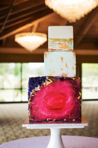 Bold, Modern Magenta, Purple, White and Gold Three Tiered Square Cube Geode Wedding Cake on White Marble Stand | Tampa Bay Wedding Bakery The Artistic Whisk