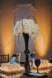 Modern, Sophisticated Black and White Wedding Reception decor with Tall White Hydrangea Centerpiece in Geometric Black Vase, with Black Wine Glasses and Votive Candles | Tampa Bay Wedding Planner UNIQUE Weddings and Events