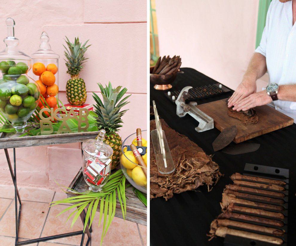 Outdoor Courtyard Old World Havana Cuban Inspired Wedding Reception Cigar Bar with Tropical Fruit, Palm Fronds, and Pineapple in Glass Jars, and Cigar Roller